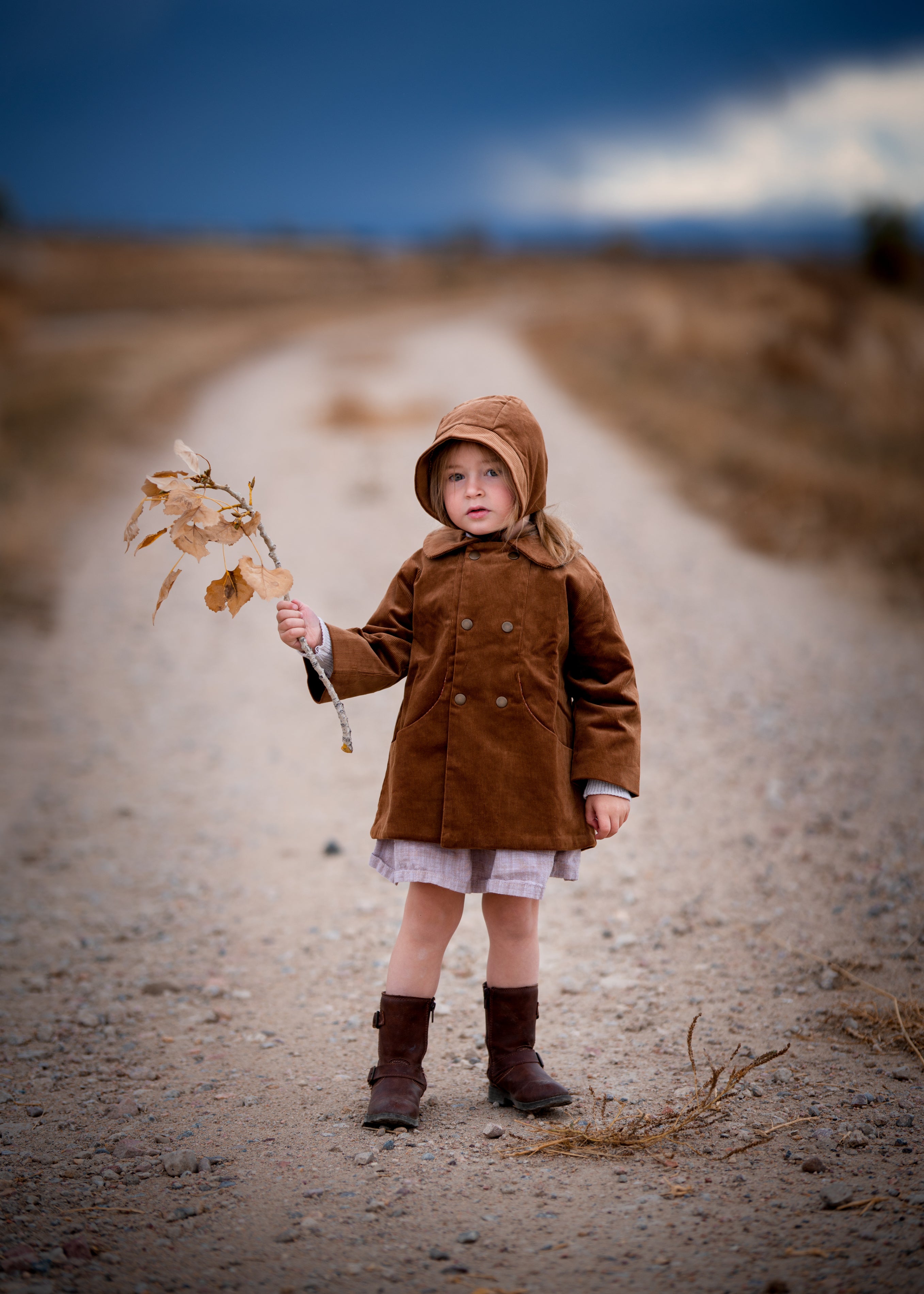 Model girl wearing the Camel Bonnet, front view - This image features the model showcasing the bonnet from the front, highlighting its snug fit and timeless style on the little one.