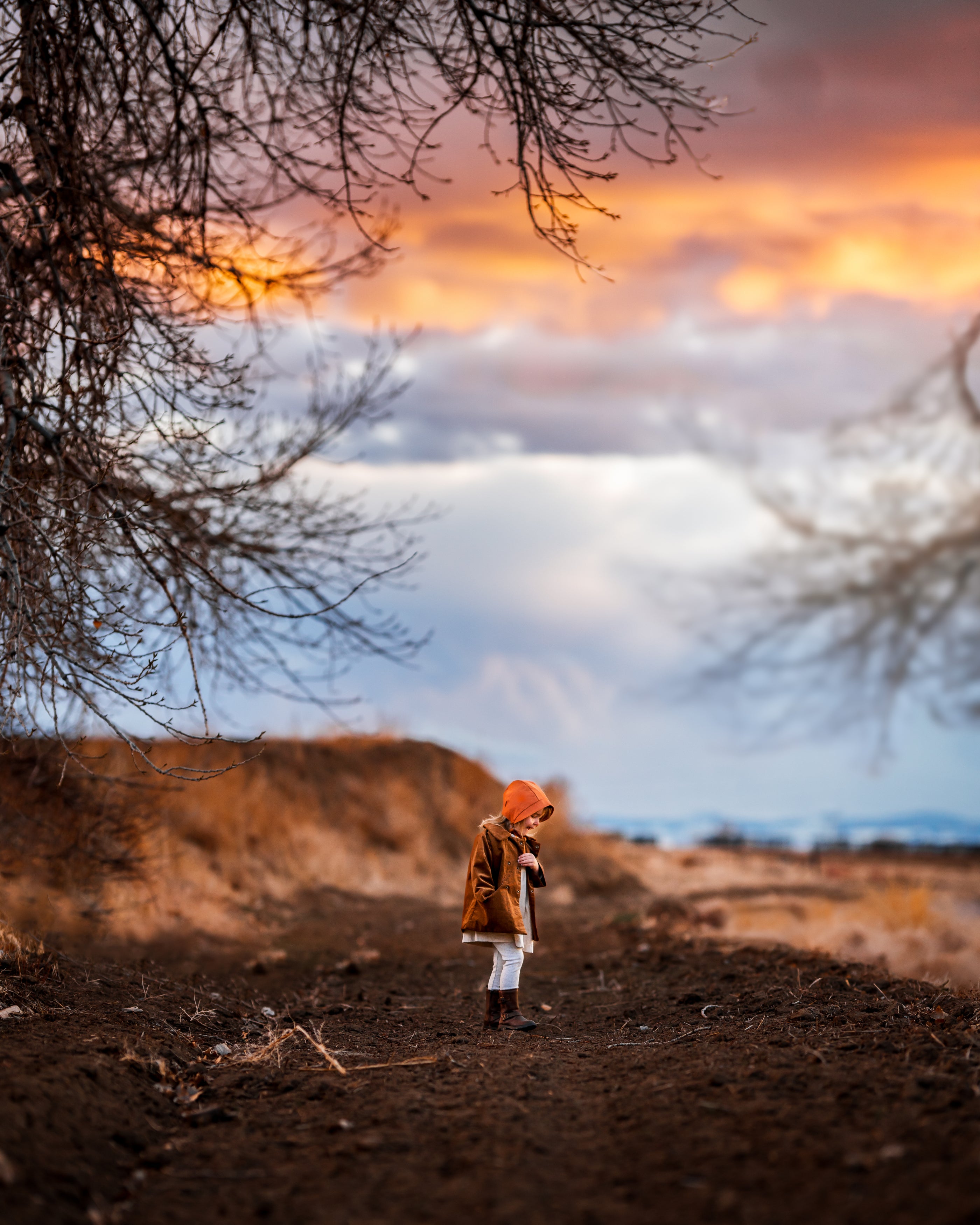 Far Away Walking with Burnt Orange Bonnet: A full-body shot of girl walking gracefully in her Burnt Orange bonnet and matching outfit, capturing the essence of playful falldays while promoting natural, sustainable children’s wear.